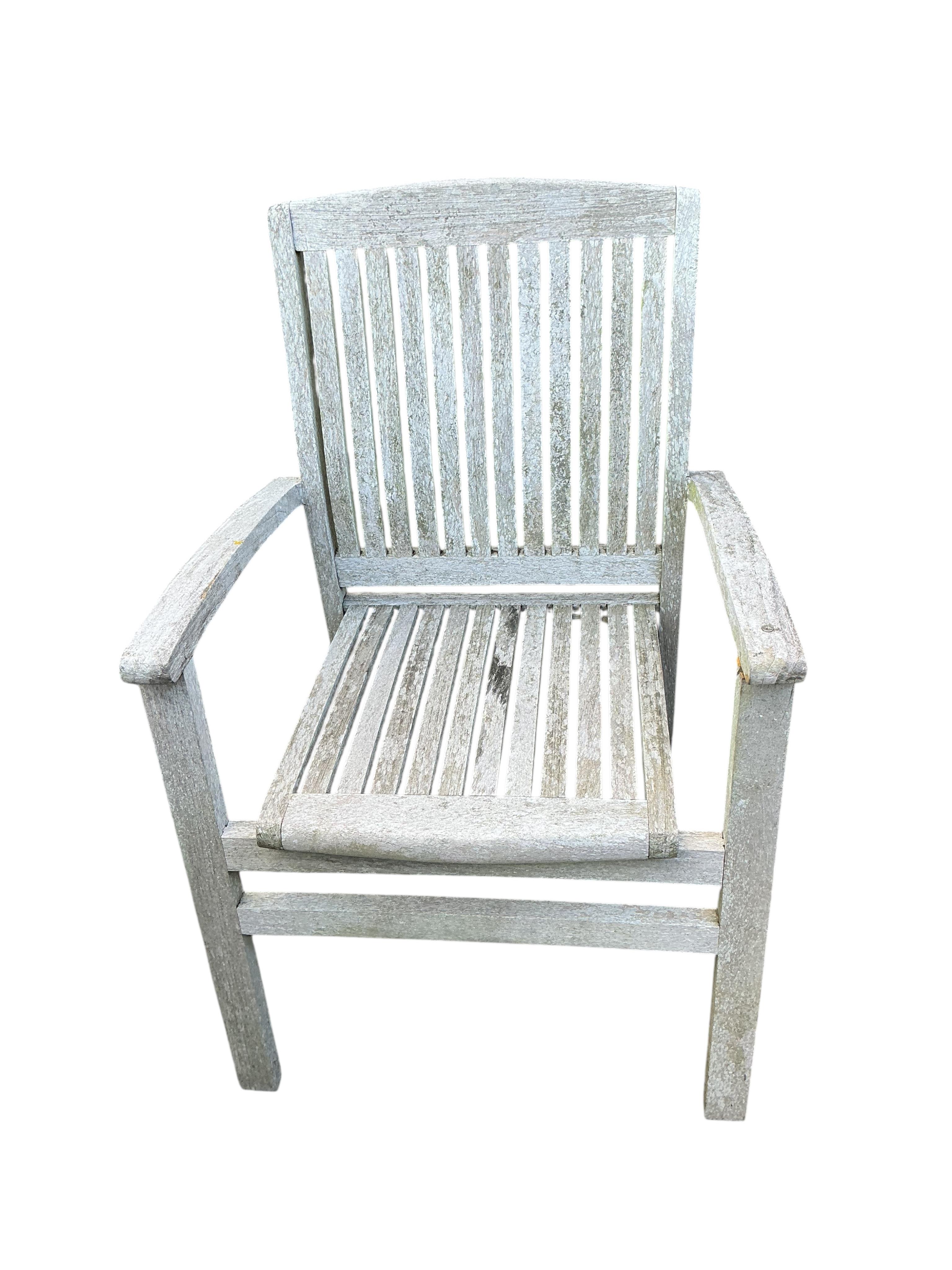 A Lindsey circular weathered teak garden table, diameter 130cm and four chairs